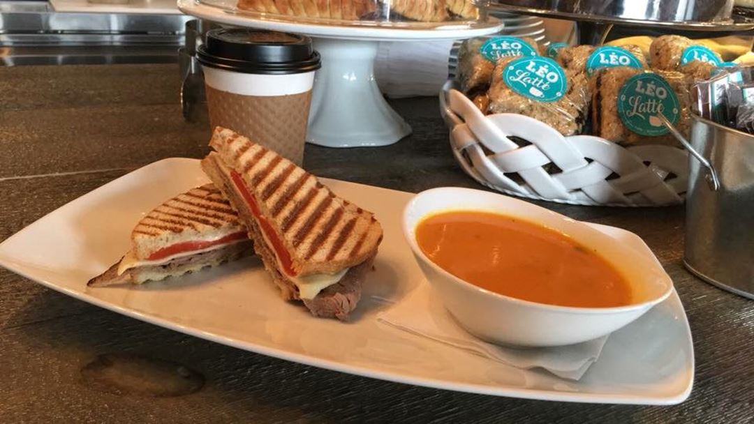 Grilled panini slices served with a vegetable soup served in a white rectangular plate and an oval bowl of white porcelain.