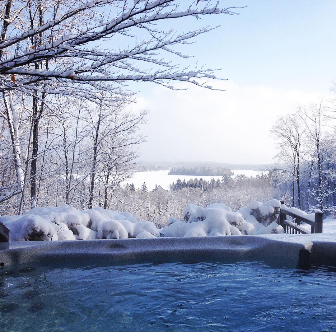 Spa avec vue sur le lac en hiver Chalets Évasion